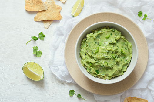 Guacamole freshly cooked and served in a bowl, overhead view