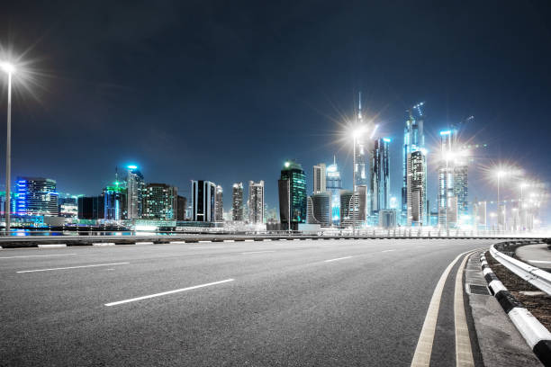 istock empty asphalt road with modern buildings at night 878160502