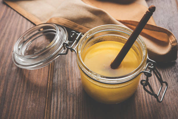 istock Desi Pure Ghee or clarified butter in glass or Copper container with spoon, selective focus 878160744