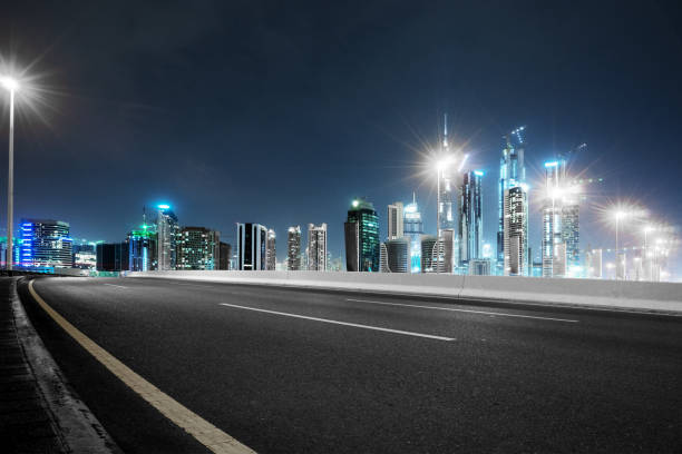 istock empty asphalt road with modern buildings at night 878161626