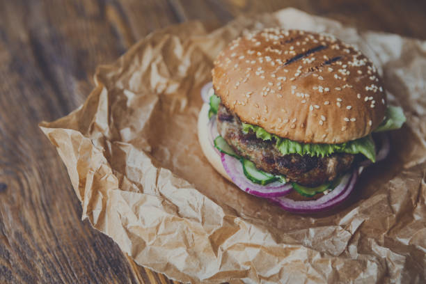 istock Classic american burger, fast food on wood background 878164152