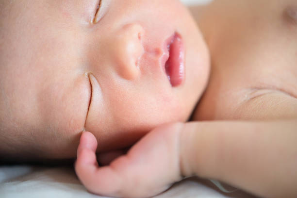 istock Close up Asian newborn baby sleeping 878169342