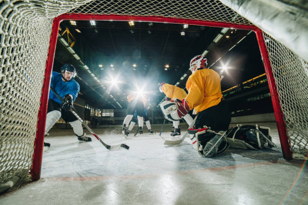istock Ice hockey player scoring while playing the match on ice hockey rink. 878169390