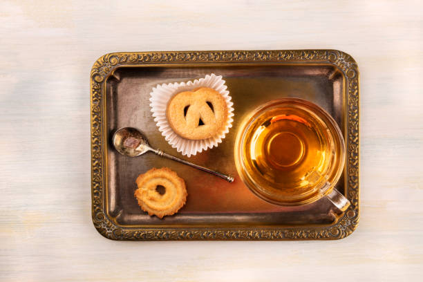 istock Danish butter cookies and tea on vintage tray with copyspace 878169578