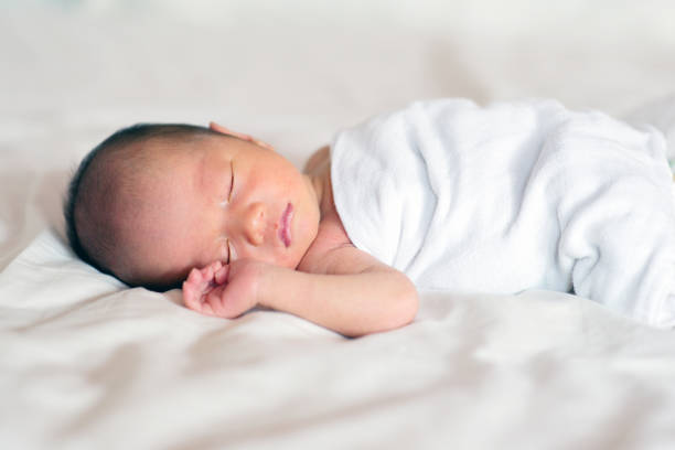 istock Asian newborn baby boy sleeping 878169934