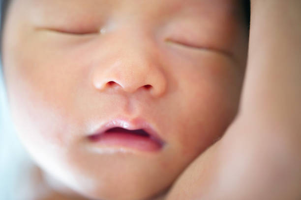 istock New born baby sleeping close up 878173116