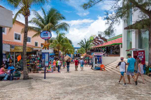 People walking along the 5th Avenue in Playa del Carmen during a summer day. The street is the shopping and restaurant centre in downtown of the city.