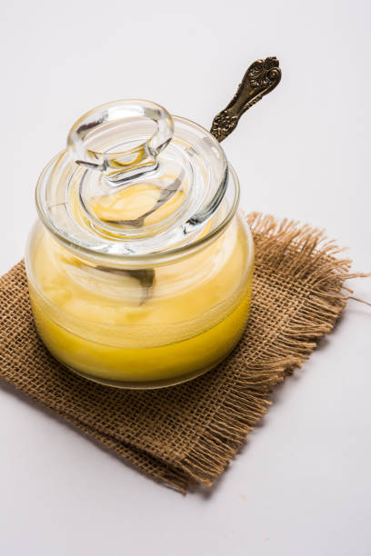 istock Desi Pure Ghee or clarified butter in glass or Copper container with spoon, selective focus 878176430