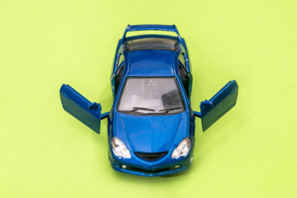 blue small toy car isolated on green, close up