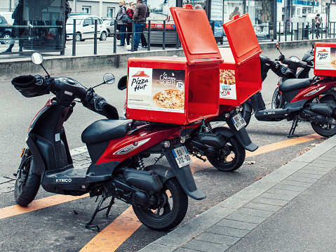 Strasbourg: Pizza-Hut delivery motorcycles parked on the street waiting for the order and delivery to the client