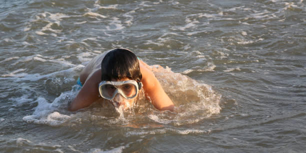 istock young boy with diving mask plays 878177140