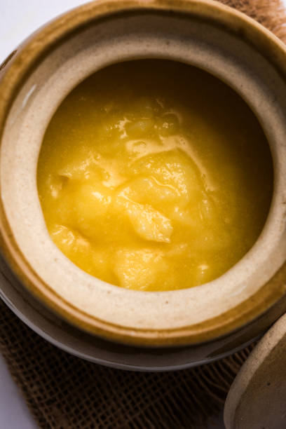 istock Desi Pure Ghee or clarified butter in glass or Copper container with spoon, selective focus 878177444