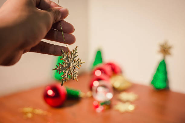 istock close up snow flake holding by hand with others and christmas decor 878179928