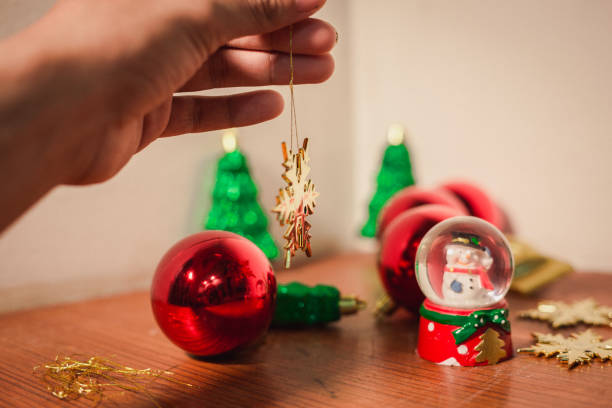 istock close up snow flake holding by hand with others and christmas decor 878179938