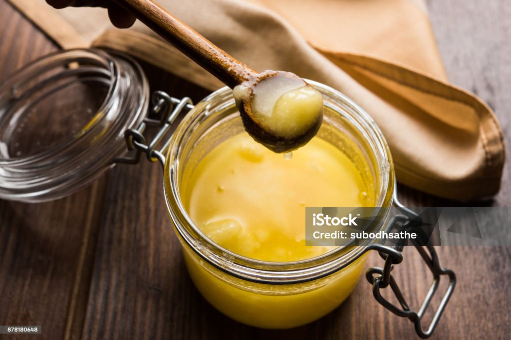 Desi Pure Ghee or clarified butter in glass or Copper container with spoon, selective focus Butter Stock Photo