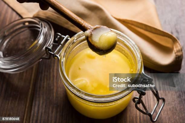 Desi Pure Ghee Or Clarified Butter In Glass Or Copper Container With Spoon Selective Focus Stock Photo - Download Image Now
