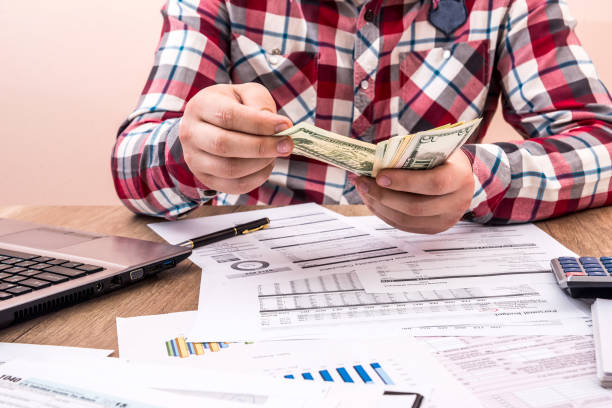 istock man counts money for office work and computer calculation of the budget 878189690