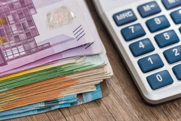 istock euro bills with calculator, close up 878190112
