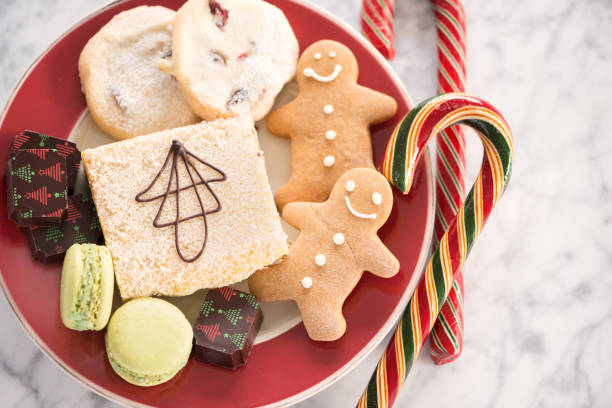 istock Christmas Themed Dessert Plate, Gingerbread Men, Candy Canes, Macaroons, Baking 878195104
