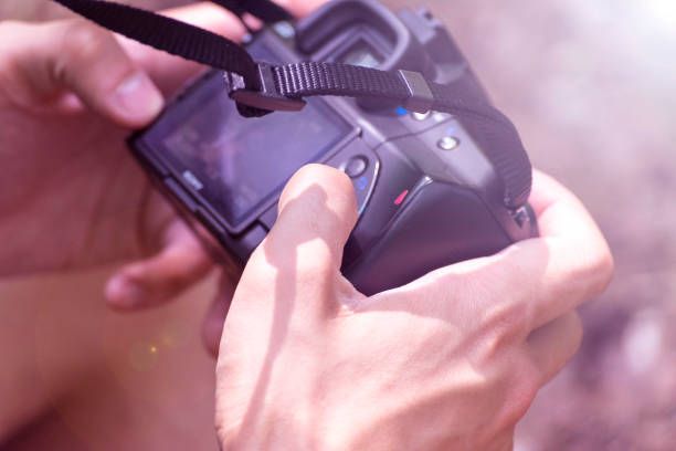 istock A man examines photos on the camera. Autumn. Summer. 878195660