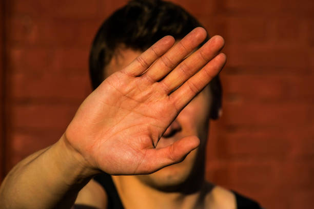 istock a young man covers his face with hand 878196070