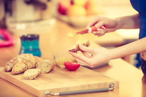 Woman preparing healthy breakfast making sandwich