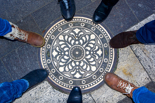 Sewer manhole on the urban asphalt road. Closeup photo.