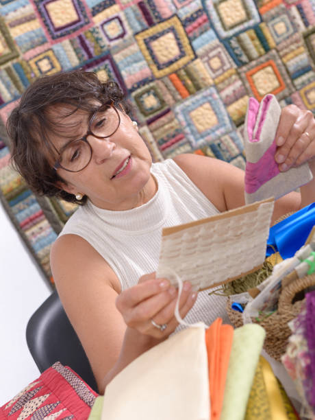 istock a pretty mature brunette woman sewing patchwork 878203662