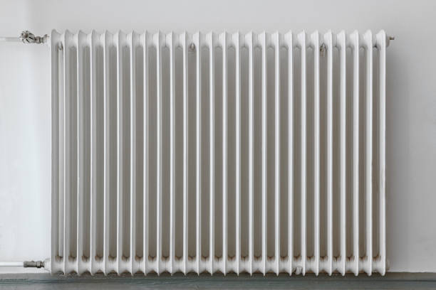 istock White heater radiator on a wall. Home appliance equipment 878204274