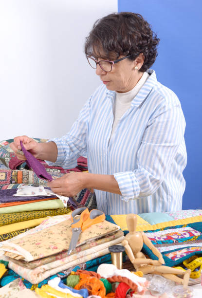istock a pretty mature brunette woman sewing patchwork 878204598
