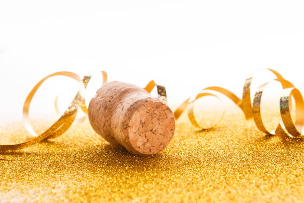 istock Champagne cork and serpentine on glitter backdrop 878208654