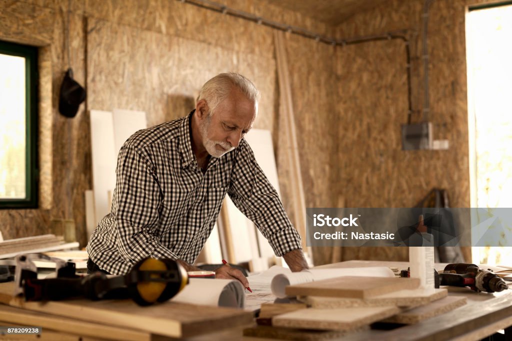 Carpenter Writing Carpenter Writing On Blueprint In His Workshop Stock Photo - Download ...