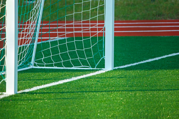istock Football field with artificial cover. 878210520