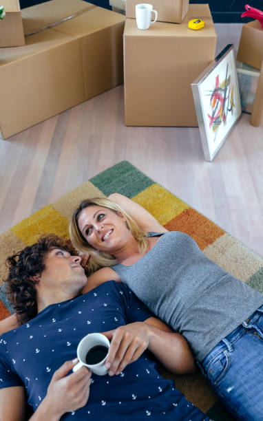istock Couple resting lying on the carpet 878211316