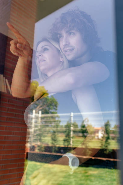 istock Couple looking at the garden through the window 878215038