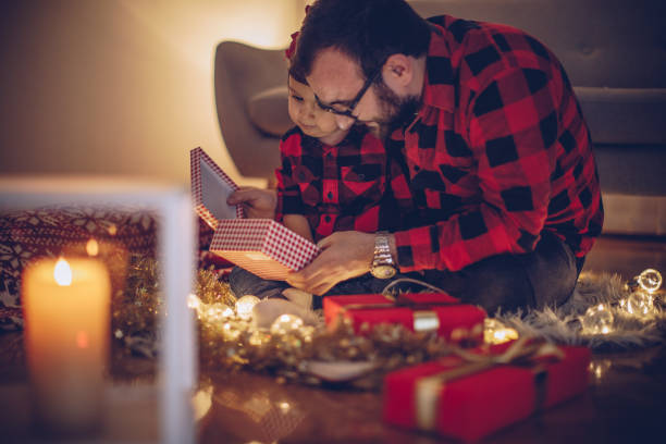 istock Father and daughter opening a Christmas gift 878215954