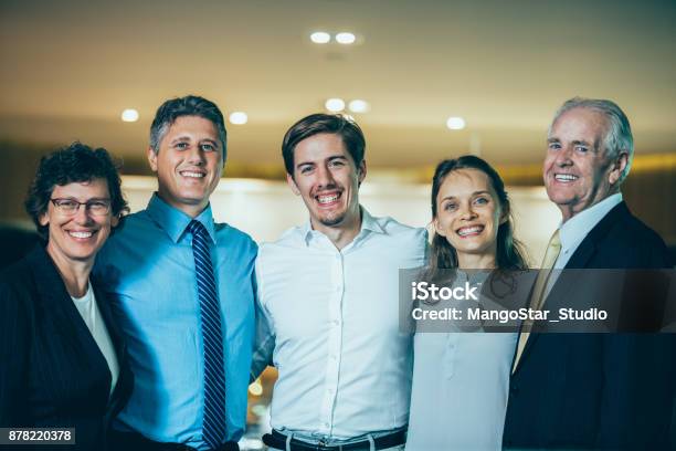 Happy Business Team Of Five People Embracing Stock Photo - Download Image Now - Businesswoman, Camera - Photographic Equipment, Senior Adult