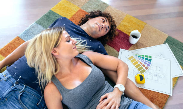 istock Couple resting lying on the carpet 878221614
