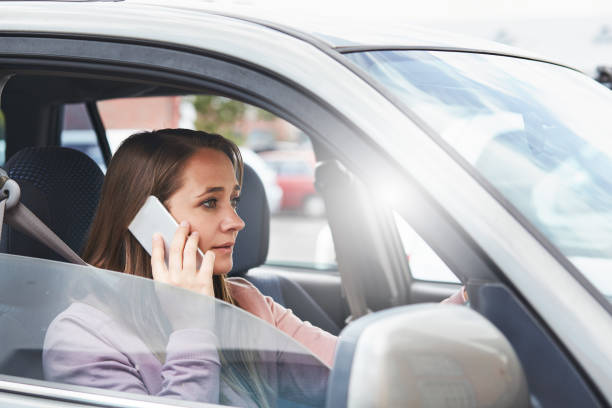 istock Beautiful blonde driver talking on smartphone 878222112