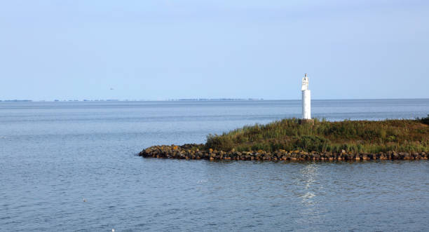 istock Great lighthouse amidst the Dutch artificial lake called ijsselm 878224798