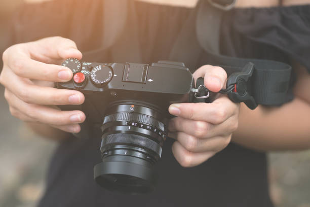 istock Female photographer, Digital camera on hand, technology, 878230362