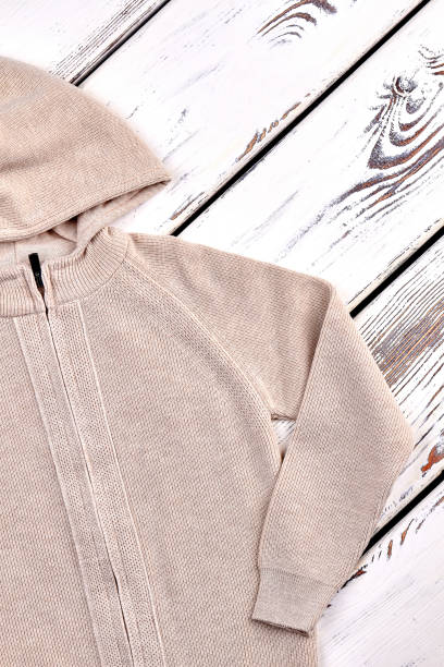 istock Kids beige knitted hooded jacket. 878230484