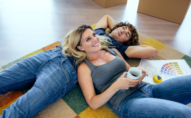 couple resting lying on the carpet - couple loving lying on back carpet imagens e fotografias de stock