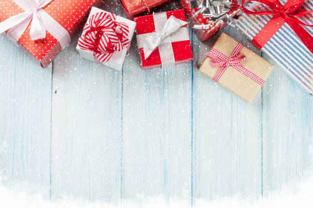 istock Christmas gift boxes on wooden table 878235390