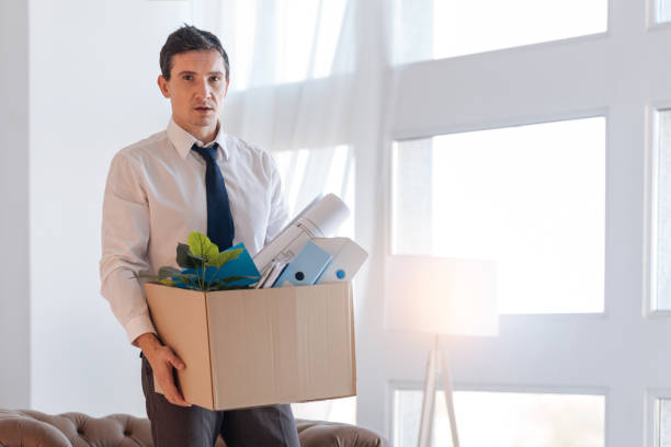 istock Exhausted disappointed man coming home after losing his job 878235880