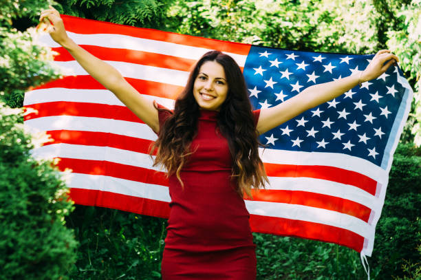 istock girl with a US flag 878239048