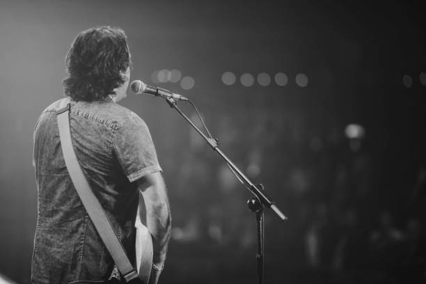 istock Rear View Of Man Singing Outdoors 878239746