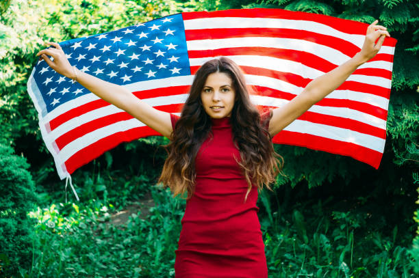 istock girl with a US flag 878240304