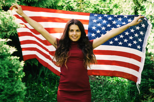 istock girl with a US flag 878245082