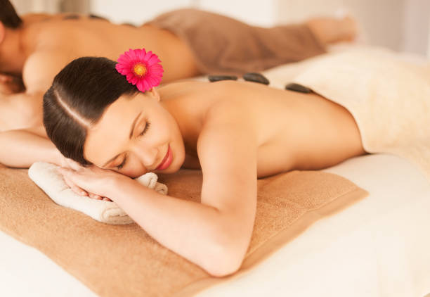 istock couple in spa with hot stones 878251500